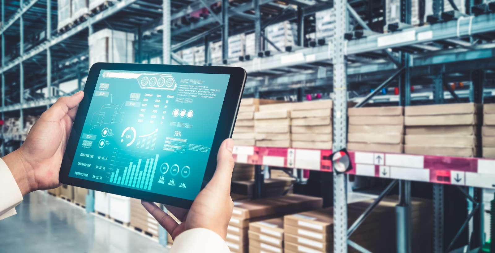 Person in einer Lagerhalle hält ein Tablett mit Tabellen hoch